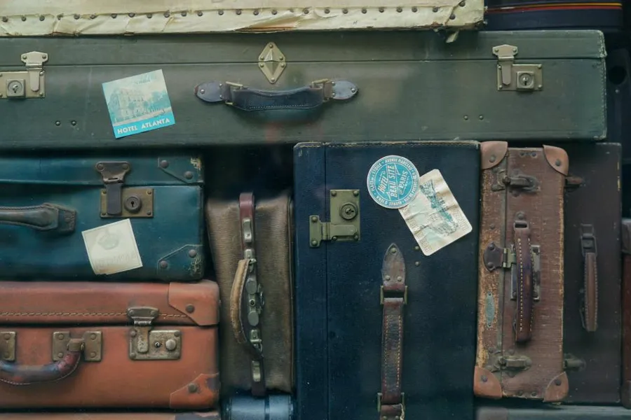 Stack of vintage suitcases with travel stickers